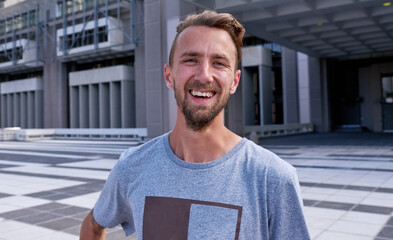 Portrait, laughing and man in city, confident and commuting on road, streetwear and funny joke on...