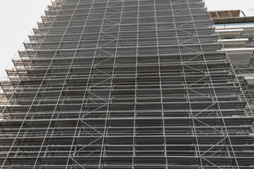 Metal Scaffolding on Building Facade, high-rise construction, maintenance project