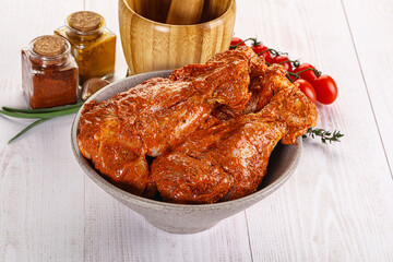 Raw turkey shoulder wing in Indian tandoori marinade
