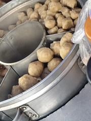 A pile of meatballs in a cart at a stall in Indonesia.