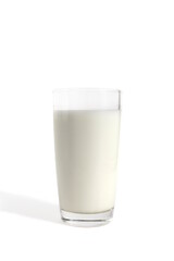 A glass of milk stands on a white background.	