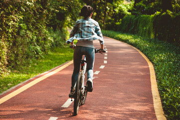 Obraz premium Fitness woman cycling in the park