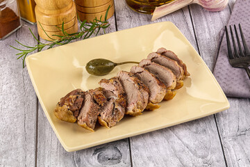 Roasted duck breast slices in the plate