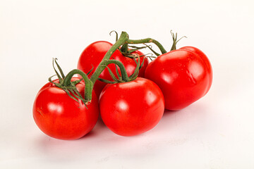 Ripe fresh tomato on the branch