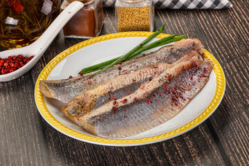 Salted marinated herring fillet with spices
