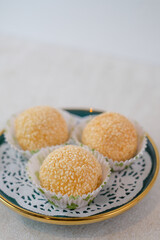 Perfectly Fried Sesame Onde-Onde With Golden Crisp Coating And Sweet Filling, Presented Beautifully On A Decorative Plate For A Delicious Dessert.
