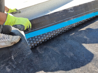 tarmac terrace insulation waterproof instalation worke working on the roof of a building