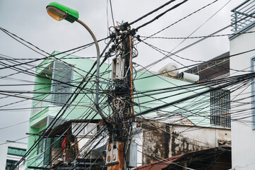 mess in the electricity wires on the street in a city in Asia in Vietnam
