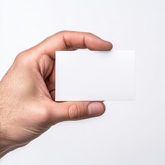Obraz premium Closeup of a single hand holding a blank white business card in bright light