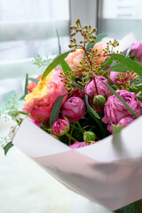 A lower bouquet of garden plants with shades of hot and erysipelas, supplemented with eucalyptus and pivonia buds. aesthetic compositions. Bright bouquet