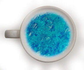 blue or turquoise summer sea with waves and boats in a cup of coffee or tea. Take a travel lake a coffee. Tourism concept foe a season trip