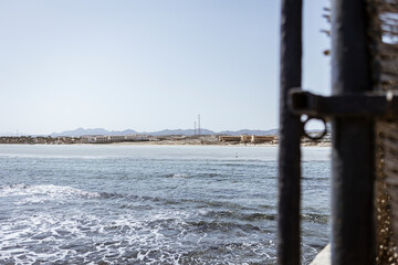 Marsa alam beach resort seen through a rusty gate in egypt