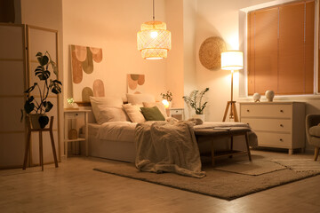 Interior of stylish cozy bedroom in evening