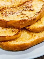 Deliciously golden French toast layered on a plate with a touch of sweetness for a perfect breakfast