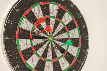 Darts hitting a target on dartboard showing the concept of business and success
