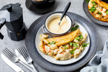 Fluffy omelet with cauliflower for breakfast with a cup of coffee