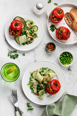 Stuffed tomatoes with couscous salad, cucumber and green peas. Mediterranean food.