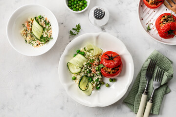 The concept of healthy eating. Turkey-stuffed tomatoes with whole wheat couscous salad