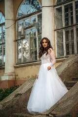 Obraz premium young beautiful girl bride in an elegant dress in the park.