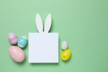 Happy Easter. Colorful eggs, bunny ears on a pastel color background, space for text or advertising