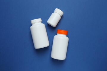 White bottles on blue background 