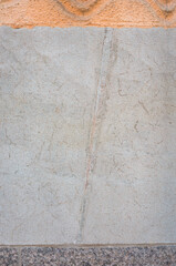 Limestone wall with a fossilized straight-shelled cephalopod from the Ordovician period, a granite...