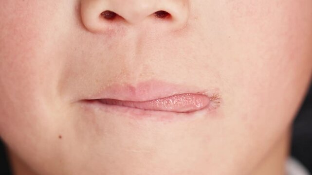 Close-up of children sticking out their tongues and licking their lips