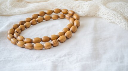 Obraz premium Elegant Wooden Beads on Soft Fabric Background for Craft Projects