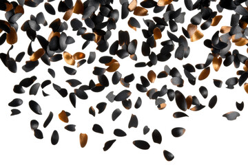 Black and gold seeds flying in the air, cut out