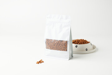 Dog Food Package Next to Bowl Filled With Kibble on a Clean Surface