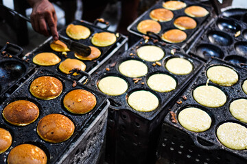 The process making Apem Cake or Kue Apem at Ngasem market (traditional market) in Yogyakarta, Indonesia. Kue Apem is traditional Javanese snacks made from rice flour.