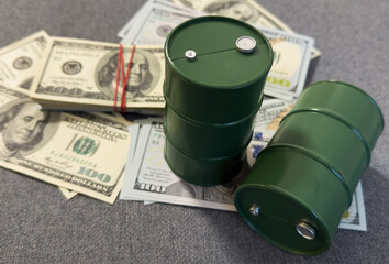 Spilled oil from a barrel to a dollar bill of money. Oil business. Profit from the sale of...