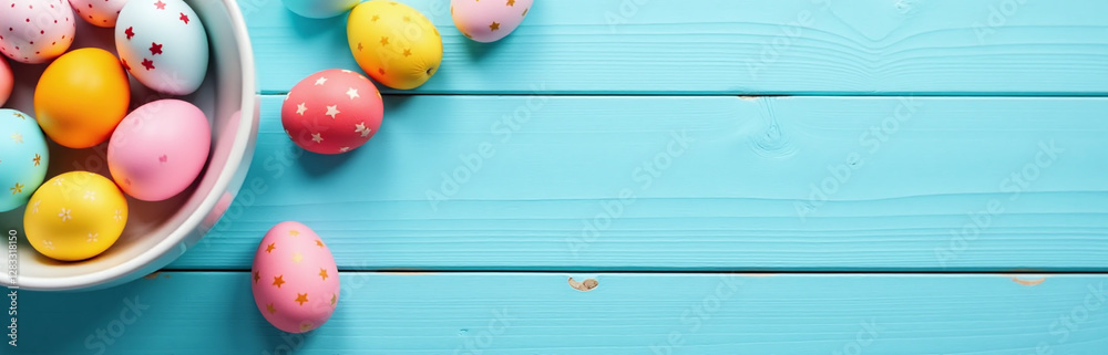 Poster colorful easter eggs on a light blue wooden table create a visually appealing flat lay composition w