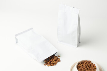 Clean and Minimalist Packaging Design of Pet Food Bags With Spilled Contents on a White Background