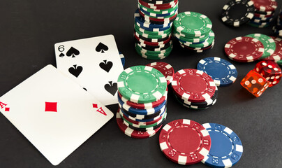 Poker cards and gambling chips on dark background