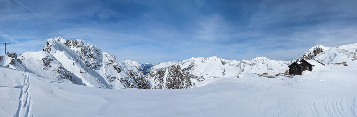 Winter panorama from Hafelekarspitze in Nordkette mountain range on a bright sunny day