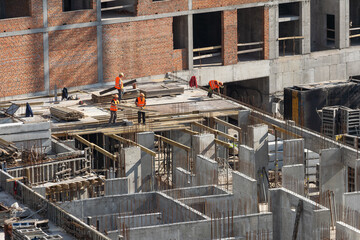 Construction worker Concrete pouring during commercial concreting floors of building in...