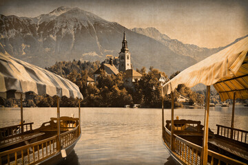 BLED LAKE THE MOST FAMOUS LAKE IN SLOVENIA with the island of the church and the tpical wooden...
