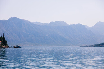 Serene mountain scenery with calm waters and distant boats