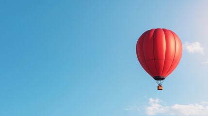 Fototapeta premium A vibrant red hot air balloon ascends gracefully against a clear blue sky, creating a picturesque aerial scene.