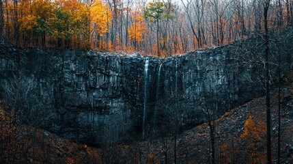 Autumn Waterfall Cascading Down a Rocky Cliff