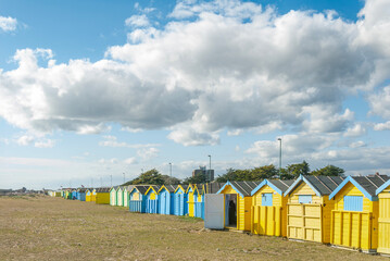 Colourful beach huts along the scenic East Sussex coastline, England