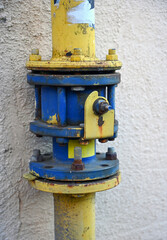 Colorful industrial pipe connection on a wall with a unique design in a utility area