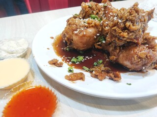 Honey sauce chicken served on a white plate
