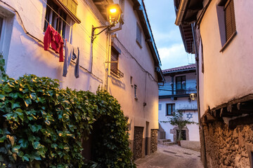 Beautiful nightfall view of a typical and narrow street in the Jewish Quarter of Hervás at night, ...
