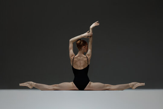 Young beautiful ballerina is posing in studio