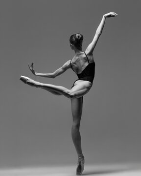Young beautiful ballerina is posing in studio