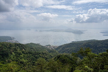 A view over Lake Taal and the Taal Volcano, from Tagaytay City, the Philippines. Haze in the sky