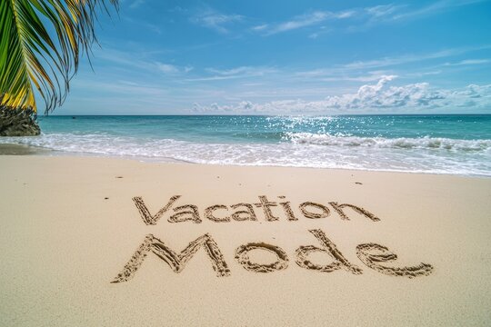 Relaxing beach scene with vacation mode written in the sand on a sunny day