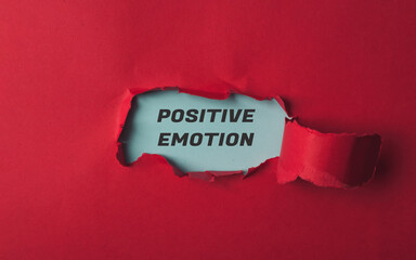 Red background with a blue word that says positive emotion written in black